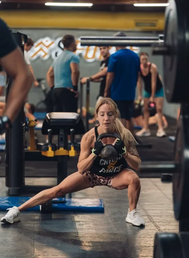 Socia entrenando con una kettlebell en plena clase
